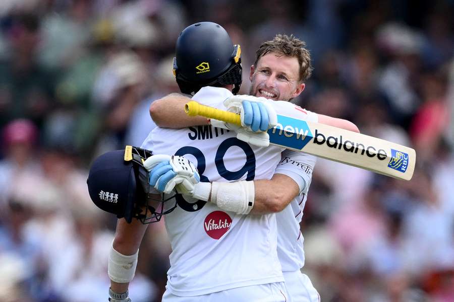 Root (R) celebrates against Australia