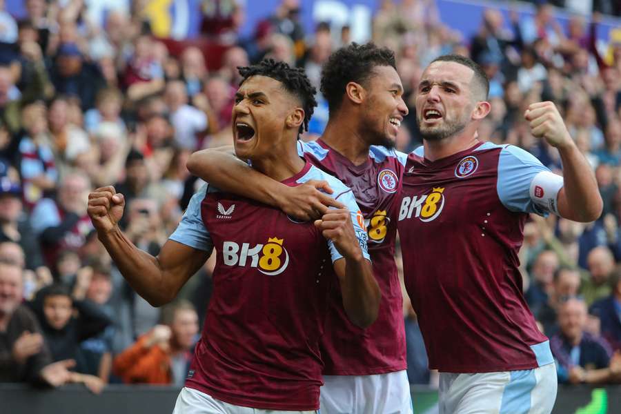 Watkins (L) celebrates his hat-trick