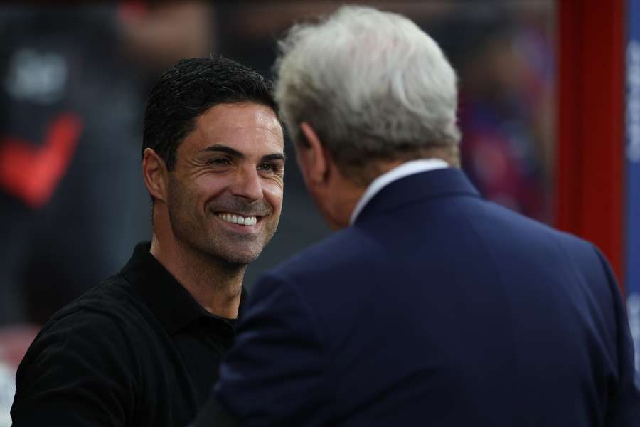 Crystal Palace's English manager Roy Hodgson (R) greets Arsenal's Spanish manager Mikel Arteta before the match