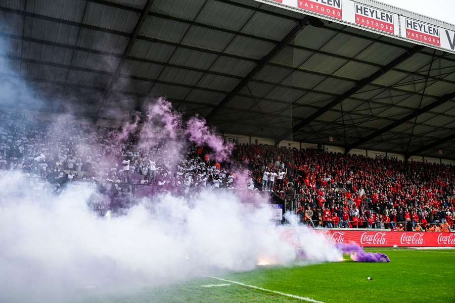 Flares on the pitch during the derby