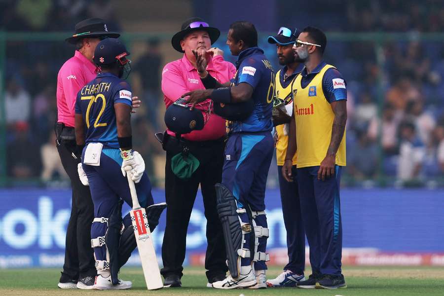 Sri Lanka's Angelo Mathews speaks to the umpires after losing his wicket due to time-out