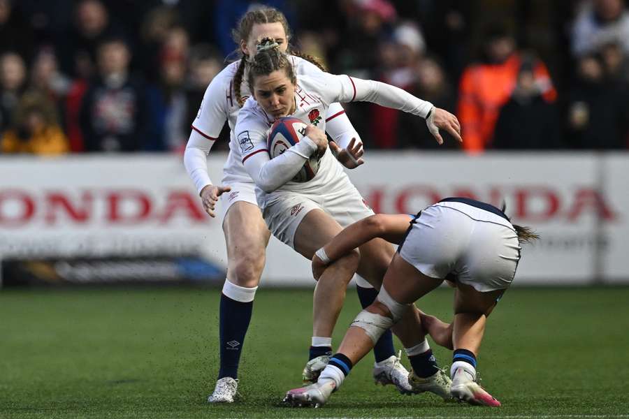 England's wing Claudia MacDonald is tackled during the Six Nations international women's rugby union match between England and Scotland 