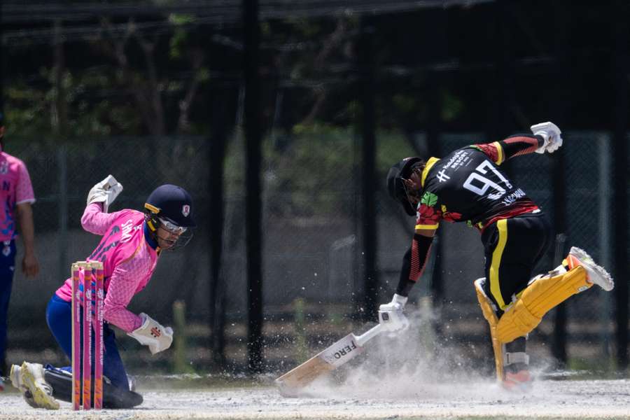 Japan’s Alex Shirai-Patmore (L) misses the ball as Vanuatu’s Junior Kaltapau runs for the crease. Japan’s Alex Shirai-Patmore (L) misses the ball as Vanuatu’s Junior Kaltapau runs for the crease.