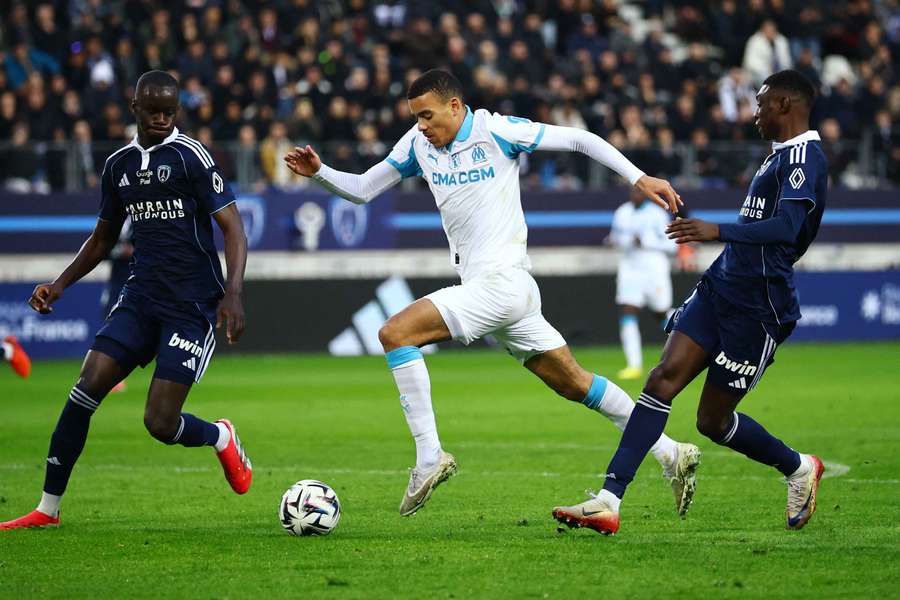 Olympique de Marseille's Mason Greenwood in action with Paris FC's Moustapha Mbow and Alimami Gory