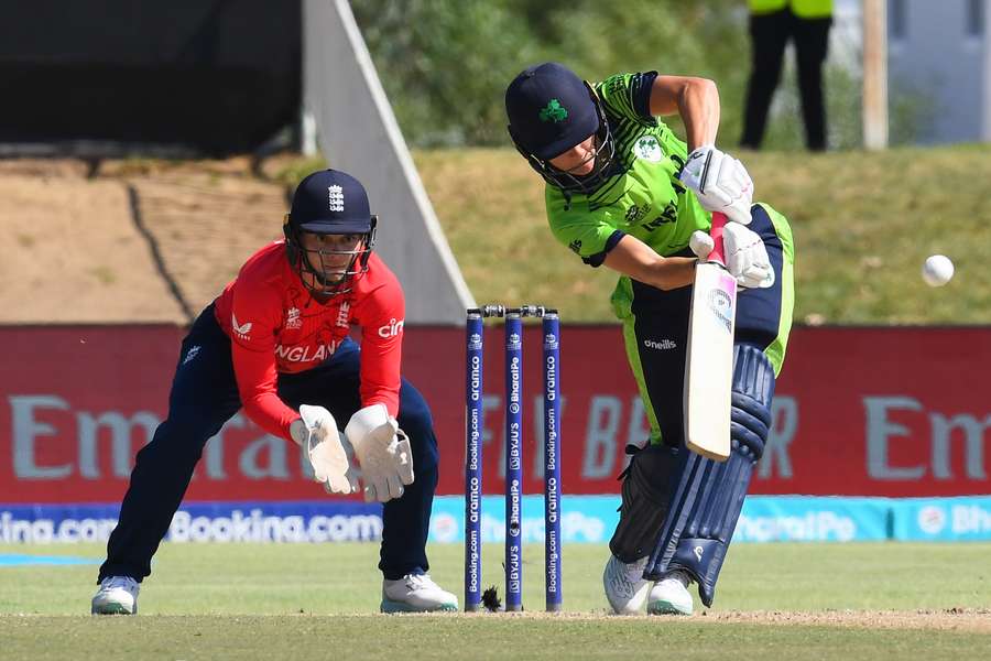 Ireland's Gaby Lewis (R) plays a shot as England's wicketkeeper Heather Knight (L) looks on