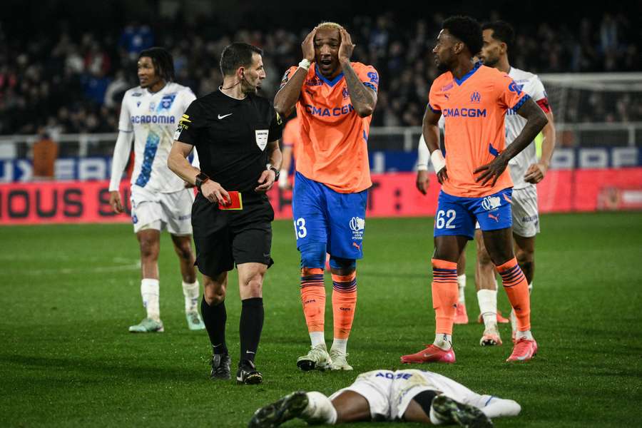 Marseille’s Canadian defender Derek Cornelius reacts after he received a red card against Auxerre