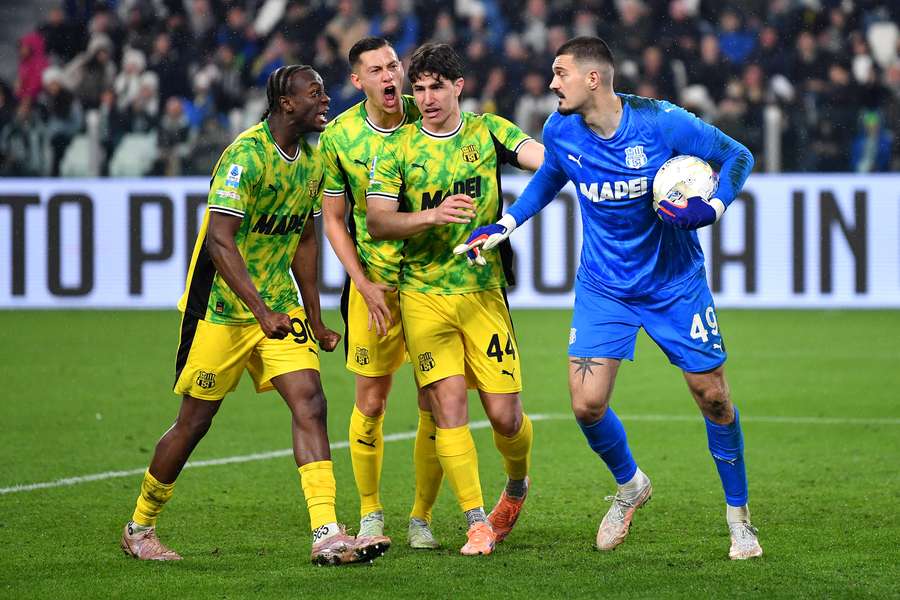 Muric and Sassuolo celebrate saving Locatelli's penalty