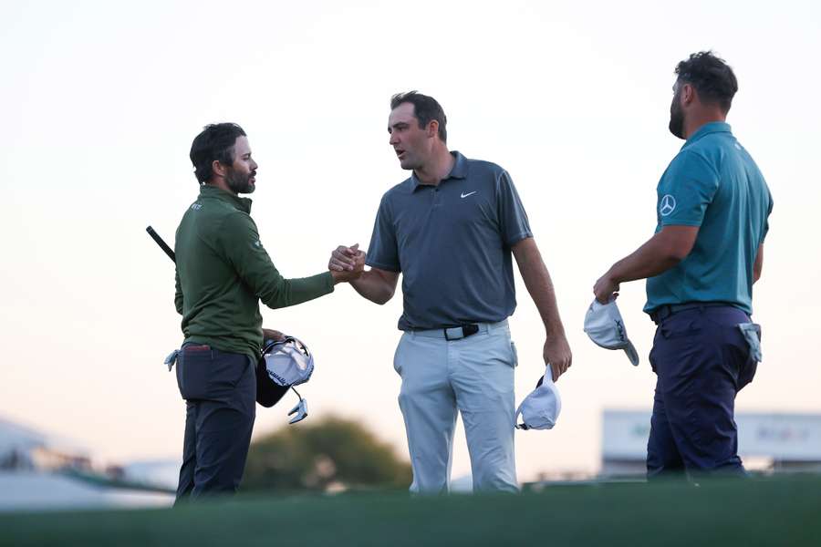 (L-R) Adam Hadwin, Scottie Scheffler and Jon Rahm complete their round