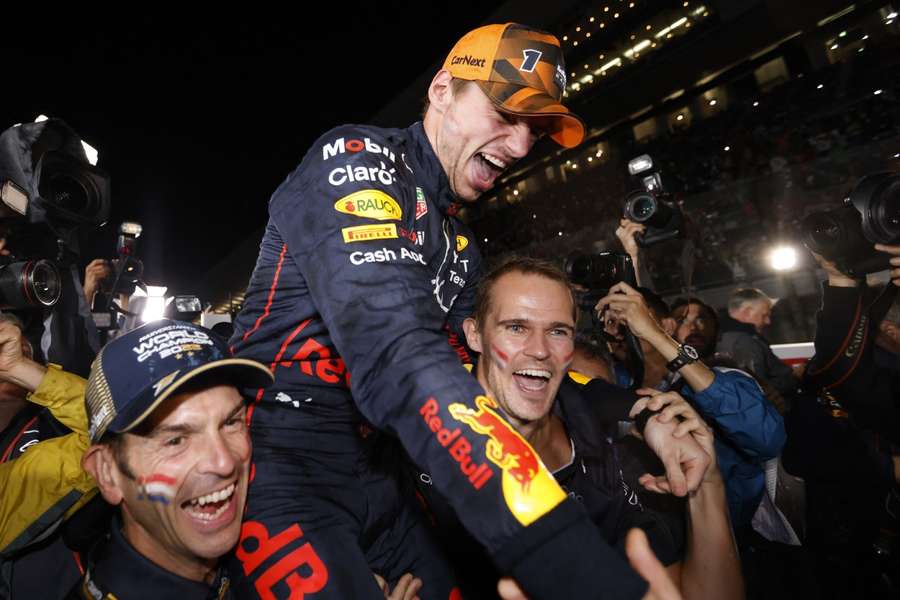 Max Verstappen celebrates winning the race and the championship with his team