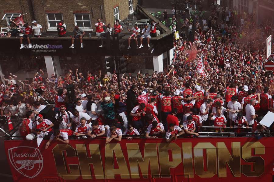 Arsenal supporters celebrate with the team Arsenal supporters celebrate with the team