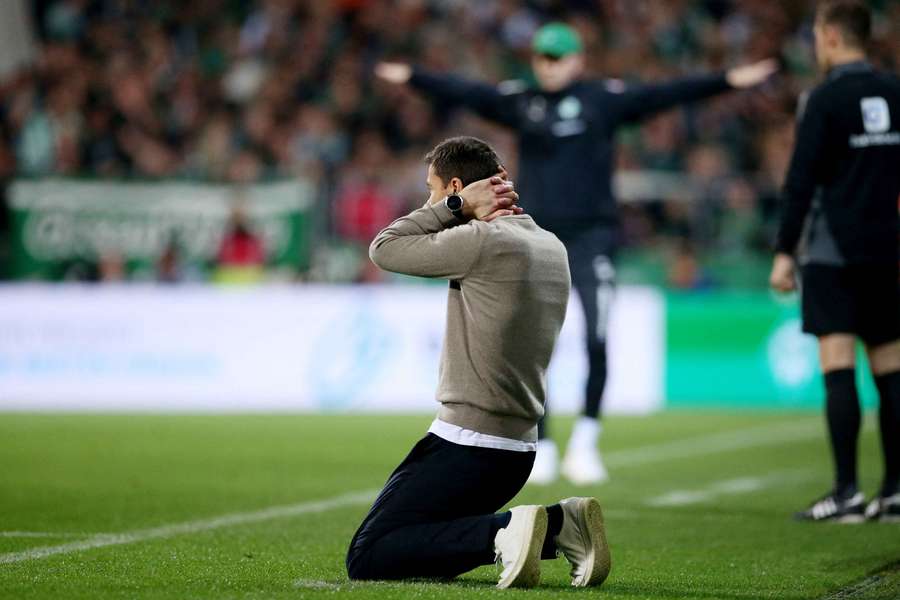 Fernando Alonso drops to his knees after the late goal for Werder Bremen