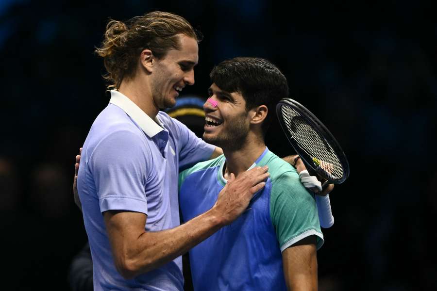 Zverev (L) hugs Alcaraz after his win