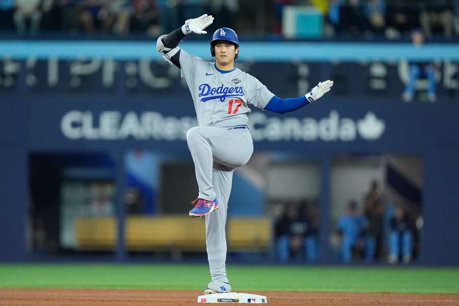 Dodgers star Shohei Ohtani celebrates after hitting a double against the Blue Jays in Game 6