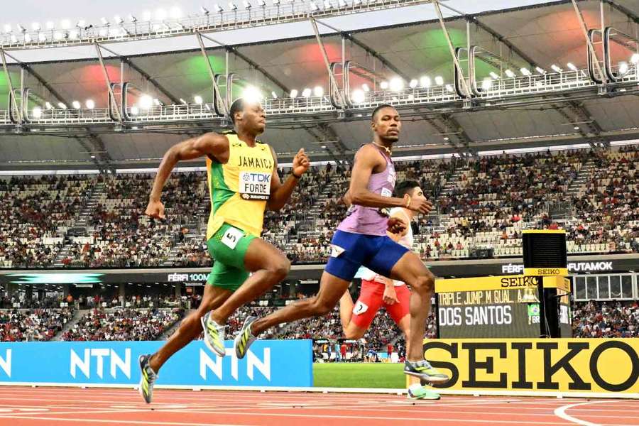 Zharnel Hughes and Ryiem Forde cross the finish line in the men's 100m heats