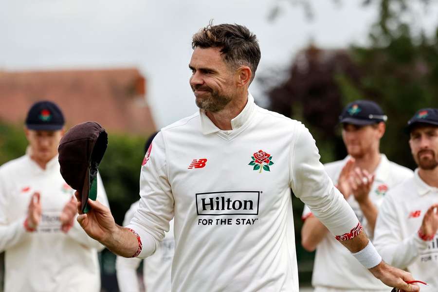Lancashire's James Anderson walks off with his team