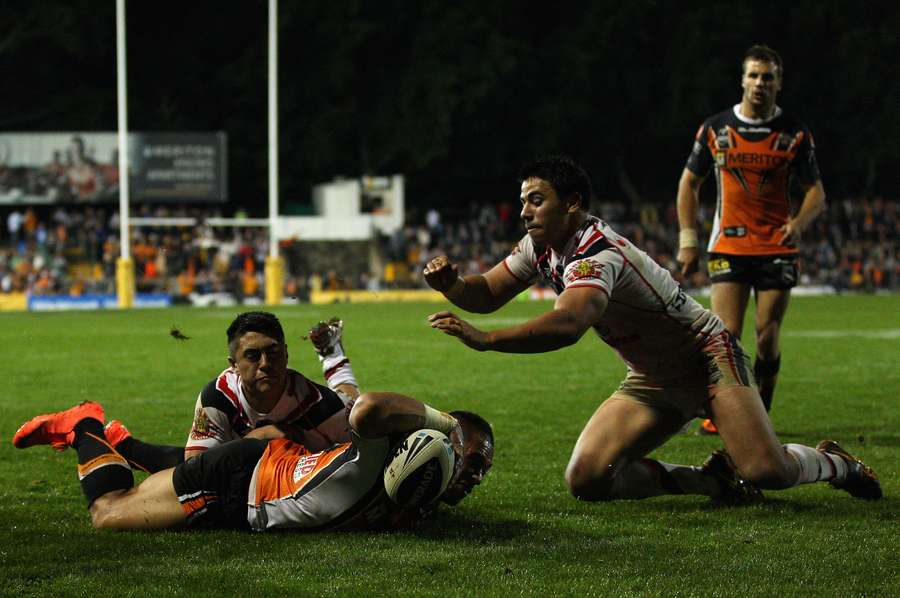 Matt Utai scores a try for Wests Tigers in 2012.