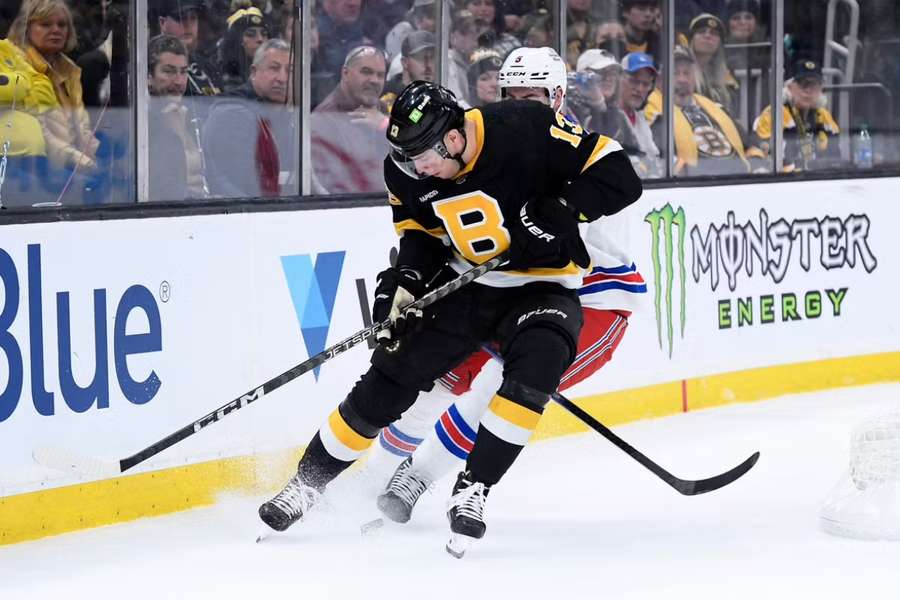 Bruins centre Coyle battles for the puck with Rangers defenceman Harpur