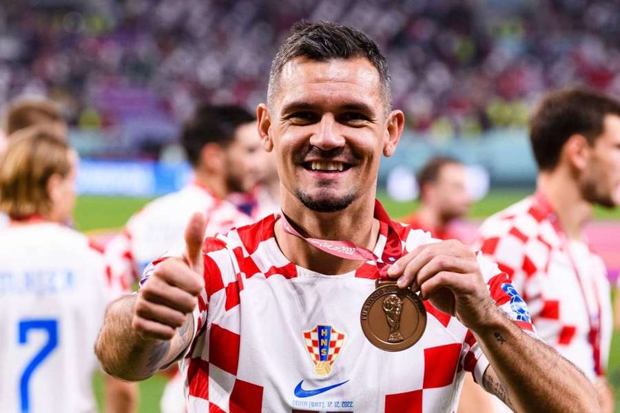 Dejan Lovren poses with the third place medal at the Qatar World Cup