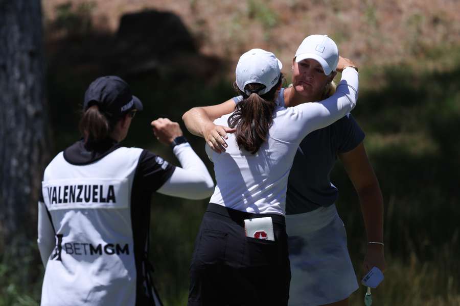 Anna Nordqvist of Sweden hugs Albane Valenzuela of Switzerland after their match on the 18th hole