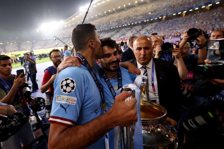 Gundogan (R) and Rodri celebrate winning the Champions League in 2023