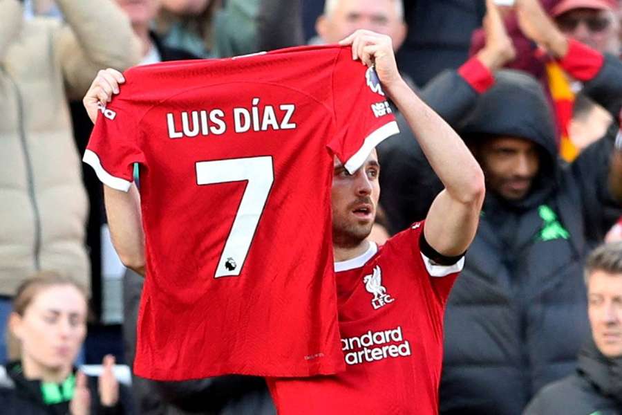 Diogo Jota holds up a shirt in support of Liverpool's Luis Diaz as he celebrates scoring their first goal 
