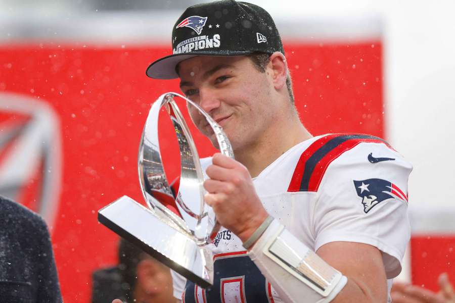 Patriots QB Drake Maye holding 2026 AFC Championship trophy