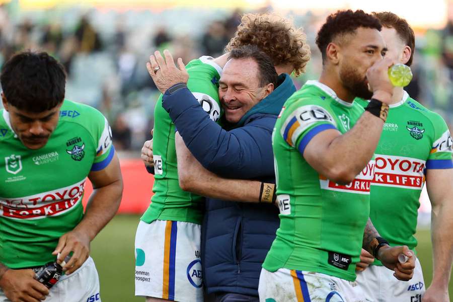 Canberra Raiders head coach Ricky Stuart embraces his son Jed after the team secured the J. J. Giltinan Shield.
