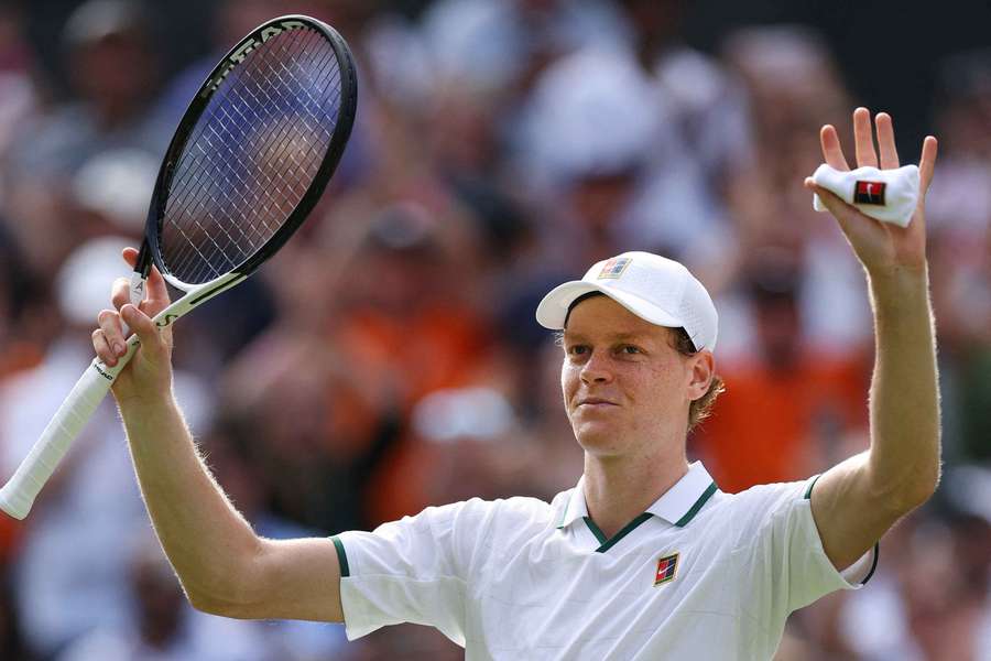 Jannik Sinner celebrates winning his first-round match against Miomir Kecmanovic