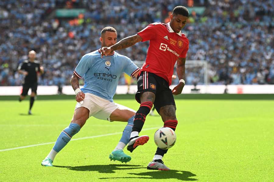 Manchester United striker Marcus Rashford (R) vies with Manchester City defender Kyle Walker (L)