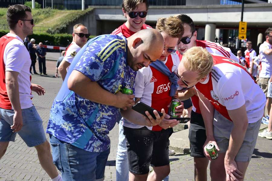Ajax fans watch the game between Feyenoord and PSV from outside the Johan Cruyff ArenA Ajax fans watch the game between Feyenoord and PSV from outside the Johan Cruyff ArenA