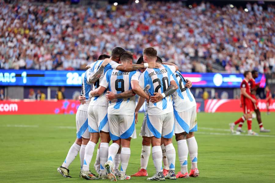 Argentina players huddle after Julian Alvarez's goal