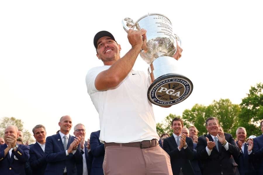 Brooks Koepka of the United States celebrates with the trophy