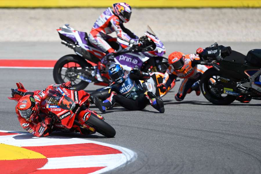 Honda Spanish rider Marc Marquez crashes with Aprilia Portuguese rider Miguel Oliveira