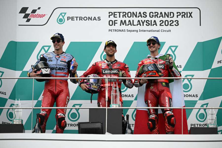 Bastianini (C) tops the podium alongside Bagnaia (R) and Marquez (L)