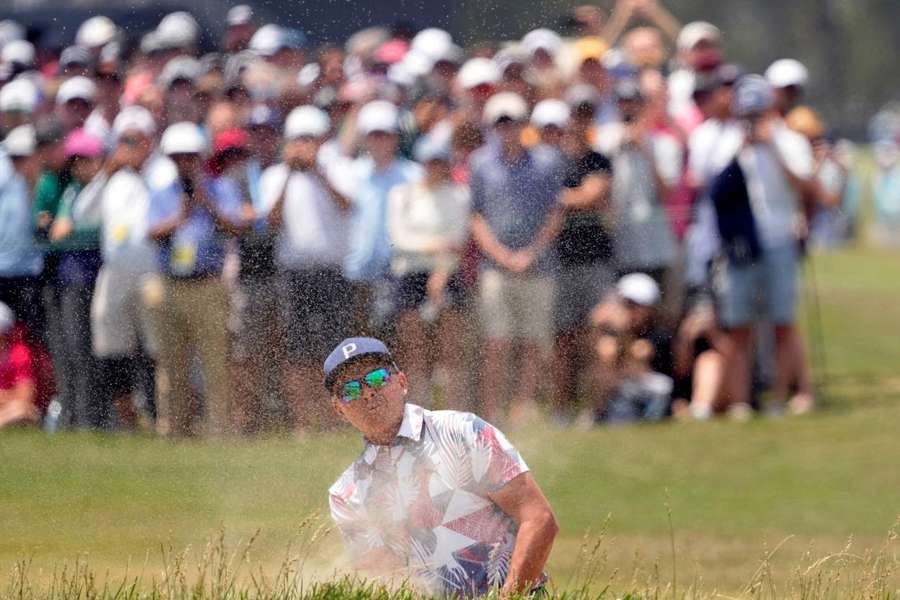 Rickie Fowler plays a shot from a bunker on the first hole during the second round