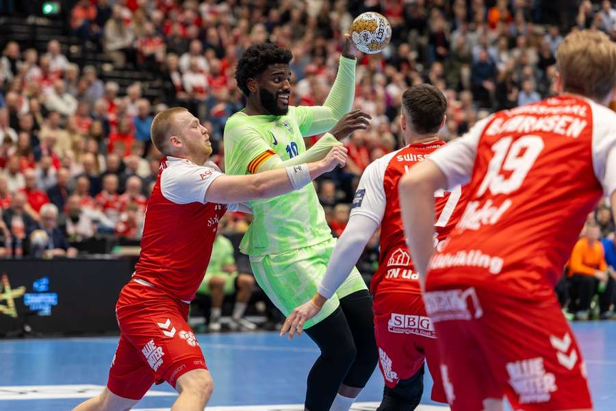 Dika Mem (10) of Barcelona and Felix Moller (L) of Aalborg Handball fight for the ball in the clash in the Champions League last year