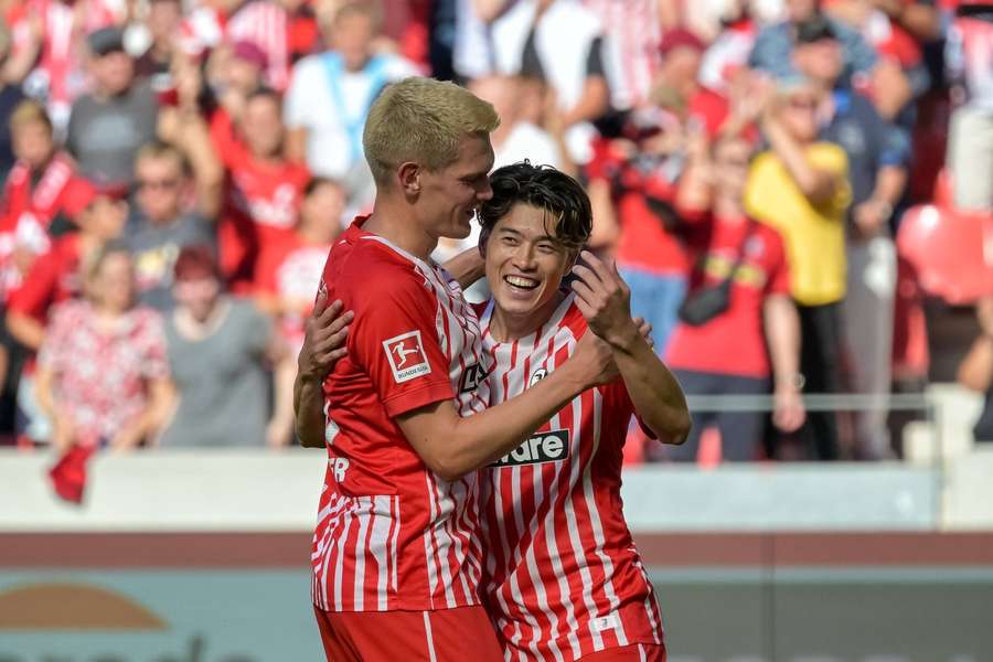 Yuito Suzuki celebrates with Mathias Ginter after scoring for SC Freiburg Yuito Suzuki celebrates with Mathias Ginter after scoring for SC Freiburg