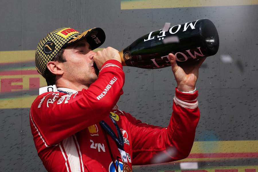 Charles Leclerc drinks champagne after winning the British Grand Prix Charles Leclerc drinks champagne after winning the British Grand Prix