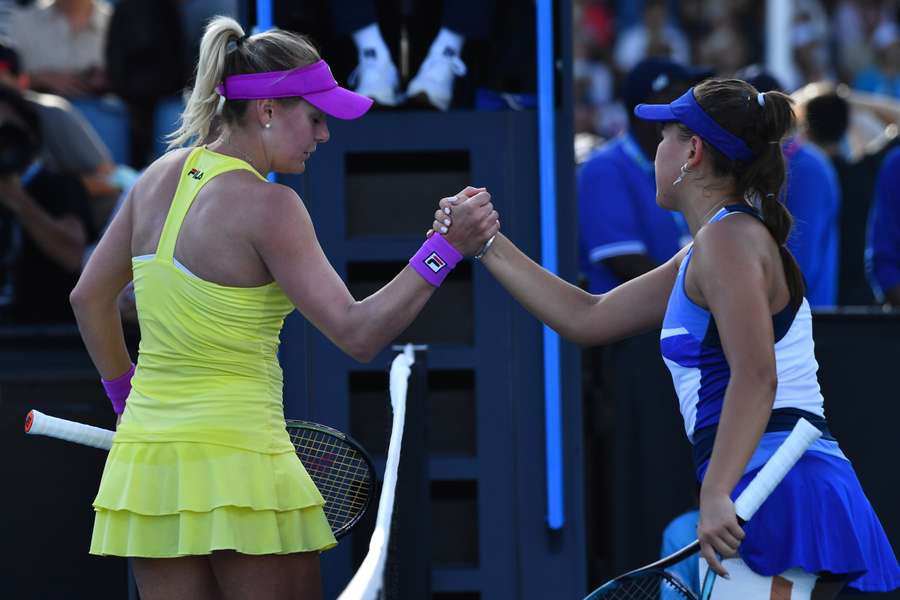 Baindl of Ukraine and Rakhimova of Russia shake hands ahead of their match