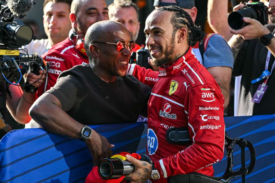 Lewis Hamilton celebrates taking pole position in Shanghai with his father