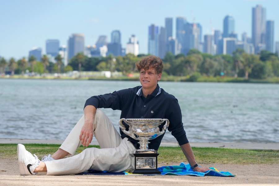 Sinner poses with his trophy