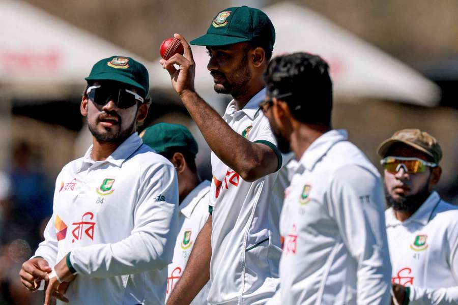 Shoriful Islam walks off with the match ball after taking seven first innings wickets.