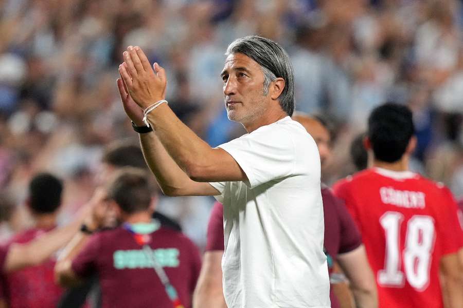 Switzerland head coach Murat Yakin applauds the supporters after the game