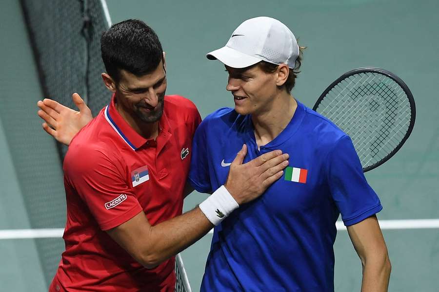 Jannik Sinner greets Novak Djokovic after winning the second men's singles semi-final