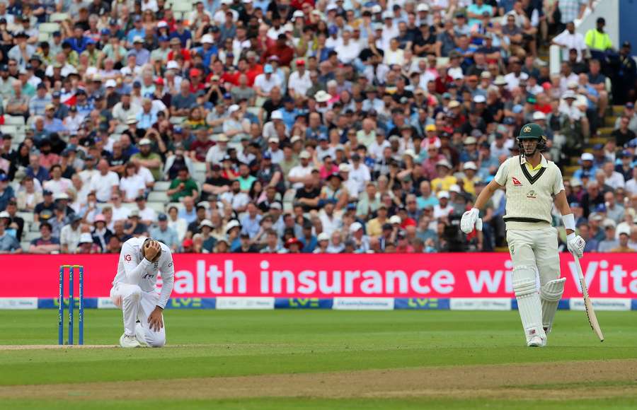 Joe Root reacts after dropping a catch from a ball hit by Pat Cummins on day five