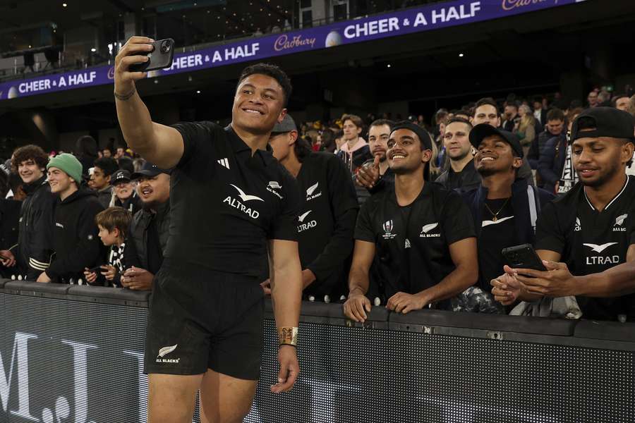New Zealand's Caleb Clarke poses for a selfie with fans