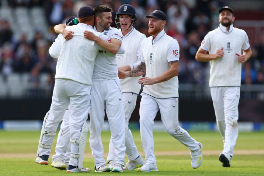 Mark Wood celebrates with Ben Stokes and Jonny Bairstow after taking the wicket of Travis Head