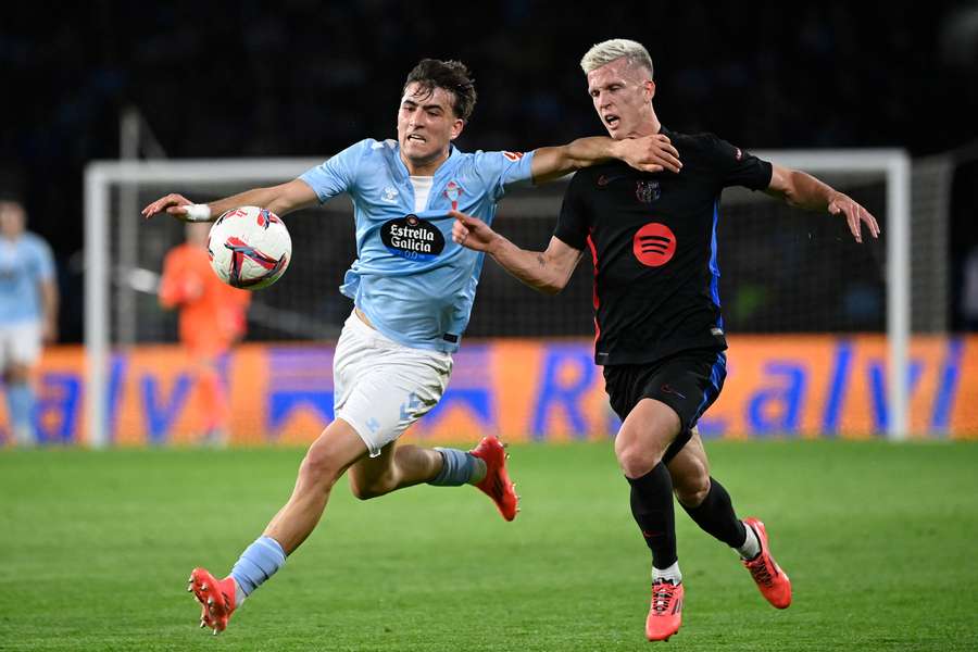 Celta Vigo's Javier Rodriguez Galiano fights for the ball with Barcelona's Daniel Olmo