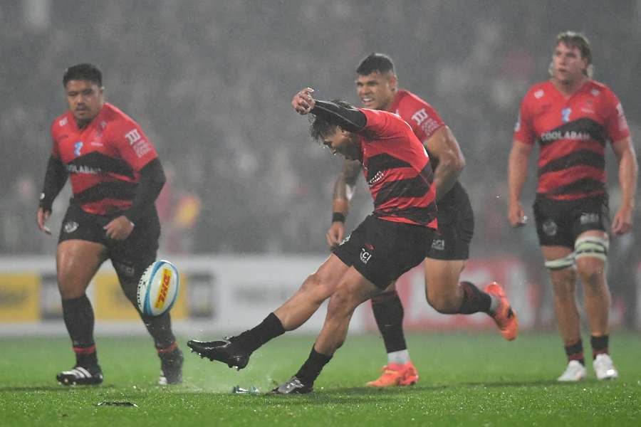 James O'Connor kicks the match-winning penalty goal for the Crusaders against the Blues. 