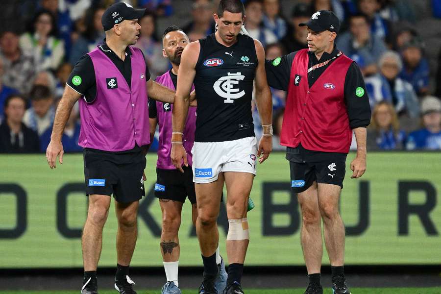 An injured Jacob Weitering is helped from the field last weekend.